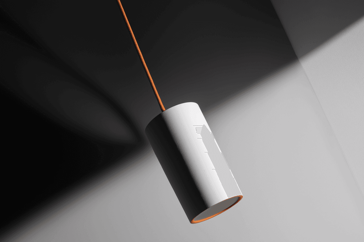 White cylindrical pendant lamp on an orange cord, lit against a black-and-white geometric backdrop
